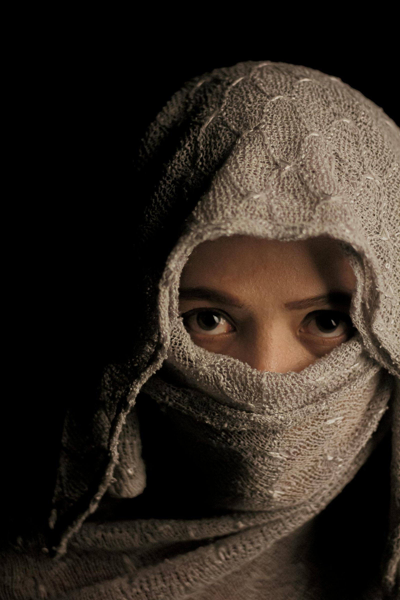 A woman wearing a veil and a scarf