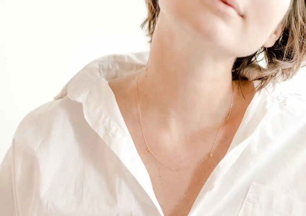 Crop gentle woman in white wear in shiny light