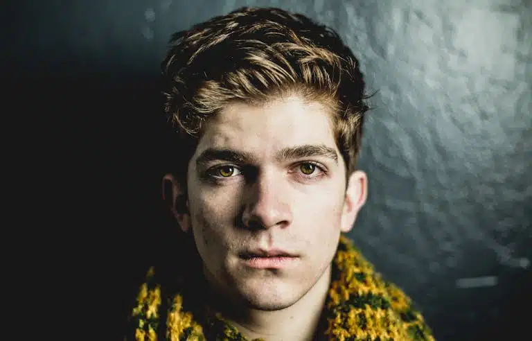 A side-by-side comparison of two male faces, one with a neutral eye tilt and the other with a negative canthal tilt. The negative tilt shows the outer corners of the eyes slightly lower than the inner corners. The image should be high-resolution, with clear facial structure details.