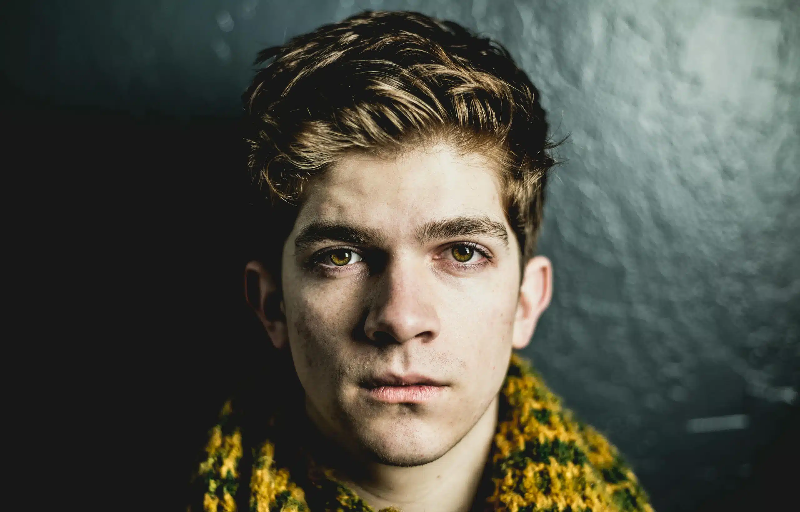 A side-by-side comparison of two male faces, one with a neutral eye tilt and the other with a negative canthal tilt. The negative tilt shows the outer corners of the eyes slightly lower than the inner corners. The image should be high-resolution, with clear facial structure details.