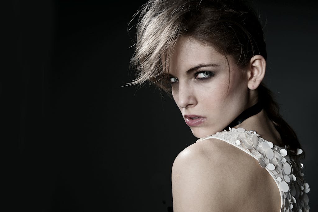 Studio portrait of a stylish young woman with a fierce look, emphasizing beauty and fashion.